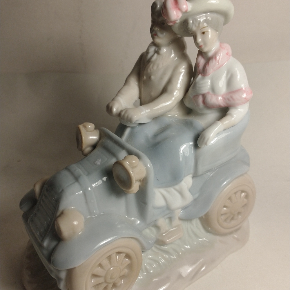 Man & Women out for a drive. Figurine.